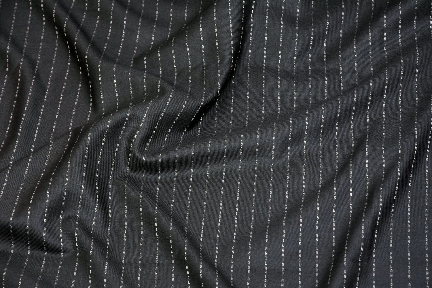 Bespoke wool suiting with name woven into the fabric
